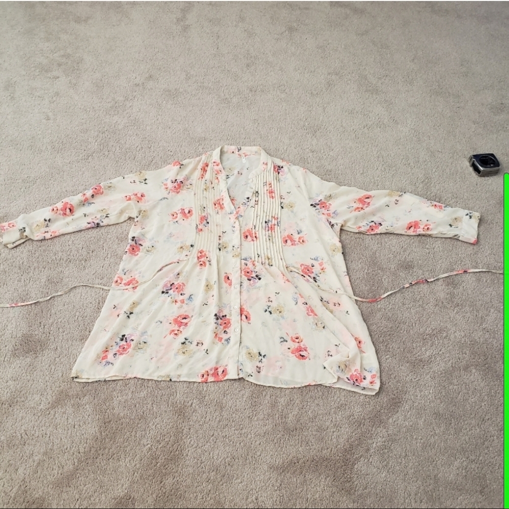 Neon pink flowers float on semi sheer cream pleats